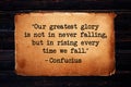 Ã¢â¬ÅOur greatest glory is not in never falling, but in rising every time we fall.Ã¢â¬Â Inspirational quote on old vintage paper. Royalty Free Stock Photo